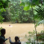 Field team crossing a river in the Endau-Rompin landscape