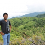  Wearing a tiger t-shirt, Musir overlooks the forests near his home village in South Aceh, Sumatra.