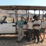 Tourists search for rhinos with a community ranger in northwestern Namibia.