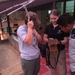Dr. Kate Jenks (Minnesota Zoo) shows some of the team members how to work the receiver to listen to the VHF radio transmissions from the sites. Photo by Jennifer Buff (Smithsonian Conservation Biology Institute volunteer)