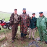 Team members dressed up in their finest rain gear to track wolves in Hustai National Park, Mongolia. From left to right: John Hart, Sanj (Hustai ranger), Dr. Kate Jenks (Minnesota Zoo Conservation Biologist), Dorj (Hustai ranger). Photo by Uuganbayar Ganbold