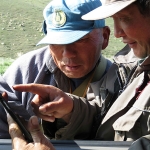 Hustai National Park rangers, Dorj and Sanj pointing out where their wolf is today. The male wolf is fitted with a GPS tracking collar that records a location every hour. Photo by Kate Jenks