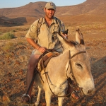 Dr. Jeff Muntifering, shown here on “donkey patrol”, leads the Zoo’s efforts to save black rhinos in Namibia (photo by Save the Rhino Trust)